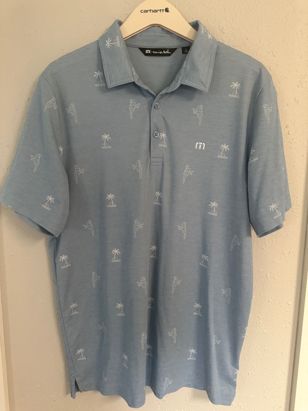 Travis Mathew Light Blue Polo with White Palm & Surfer Print